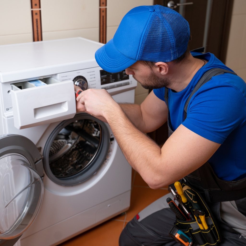 Appliance repair technician fixing washing machine in Halifax
